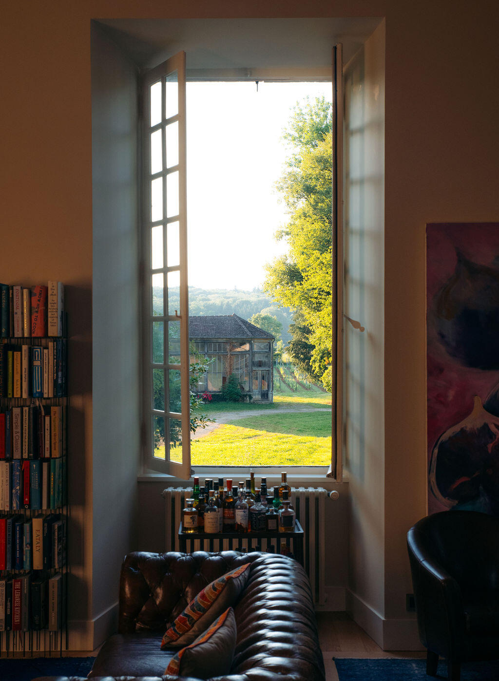 A window in the château opening onto the estate and vineyard beyond